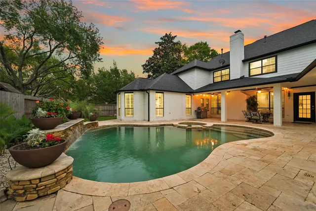 a view of a house with swimming pool and sitting area