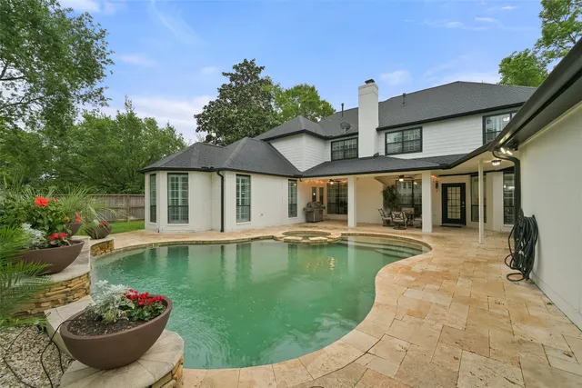 a view of a house with swimming pool and porch