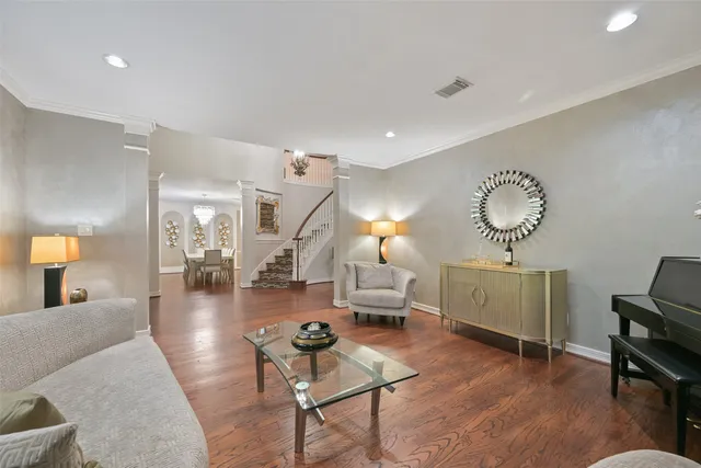 a living room with furniture and wooden floor