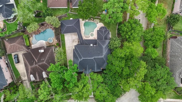 an aerial view of a house with a yard and outdoor seating
