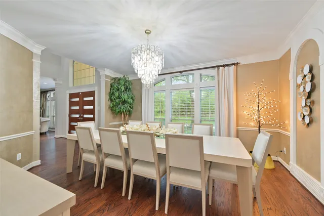 a view of a dining room with furniture wooden floor and chandelier