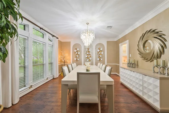 a view of a a dining room with furniture window and wooden floor