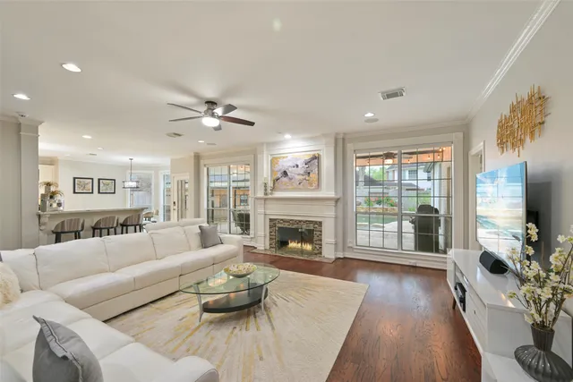 a living room with furniture fireplace and a large window