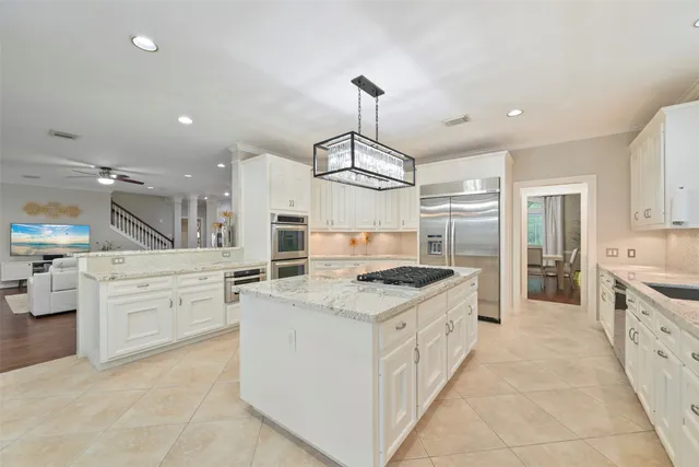a large kitchen with stainless steel appliances a stove oven and a sink