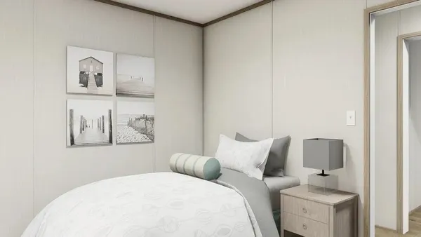 a bedroom with a bed and a painting on the wall
