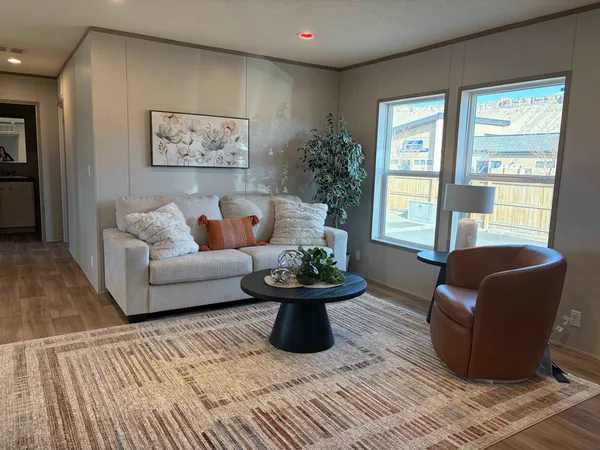a living room with furniture and a large window