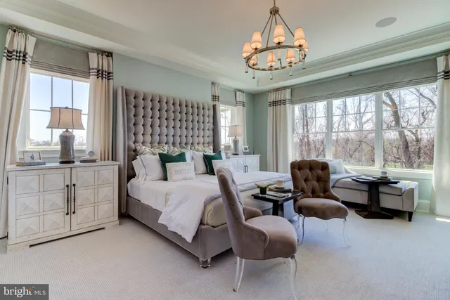 a bedroom with furniture and a large window