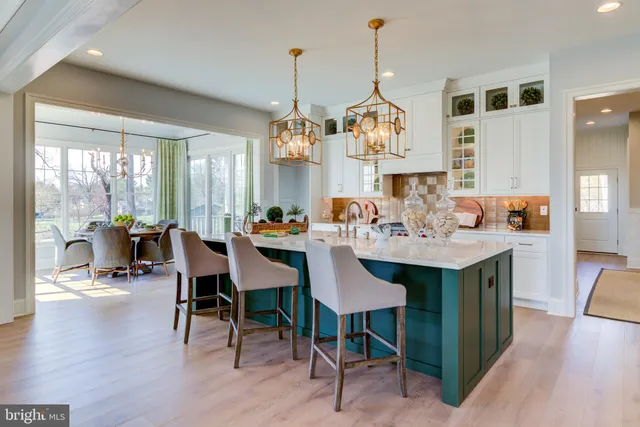 a view of a dining room and livingroom with furniture wooden floor a chandelier