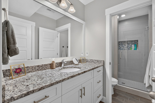 1263 East 1200th South Springville, UT 84663 - Photo 43 of 60 Bathroom featuring a white vanity with a granite countertop, undermount sink, and brushed nickel faucet