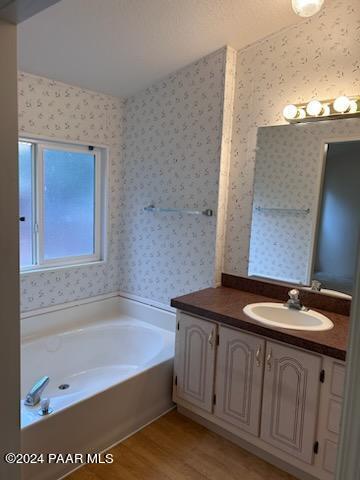 99 Alpine Prescott, AZ 86305 - Photo 12 of 25 a bathroom with a granite countertop sink a mirror and a bathtub