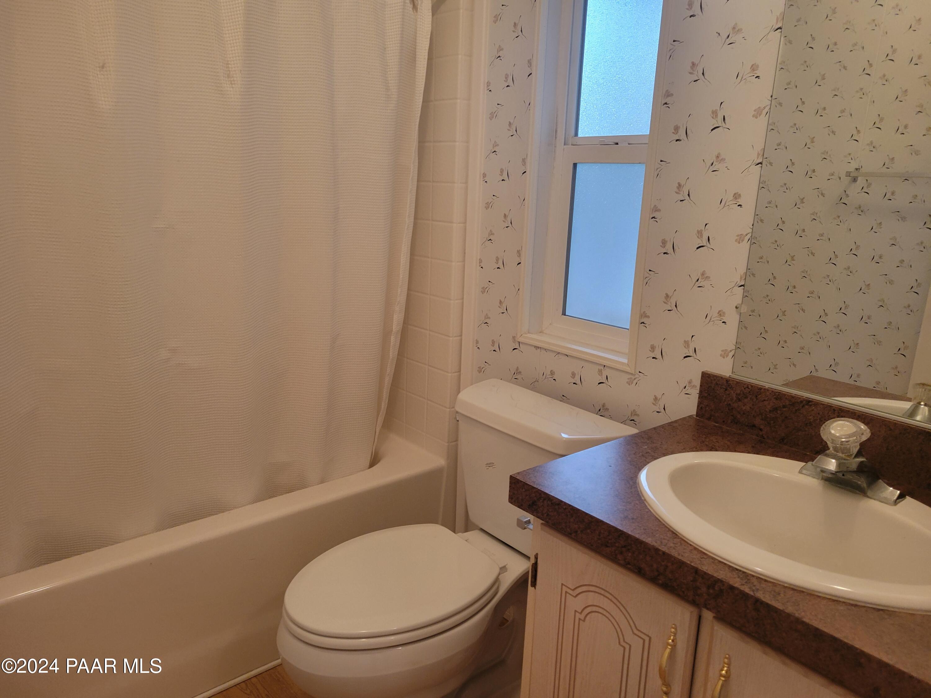 99 Alpine Prescott, AZ 86305 - Photo 18 of 25 a bathroom with a granite countertop sink toilet and a mirror