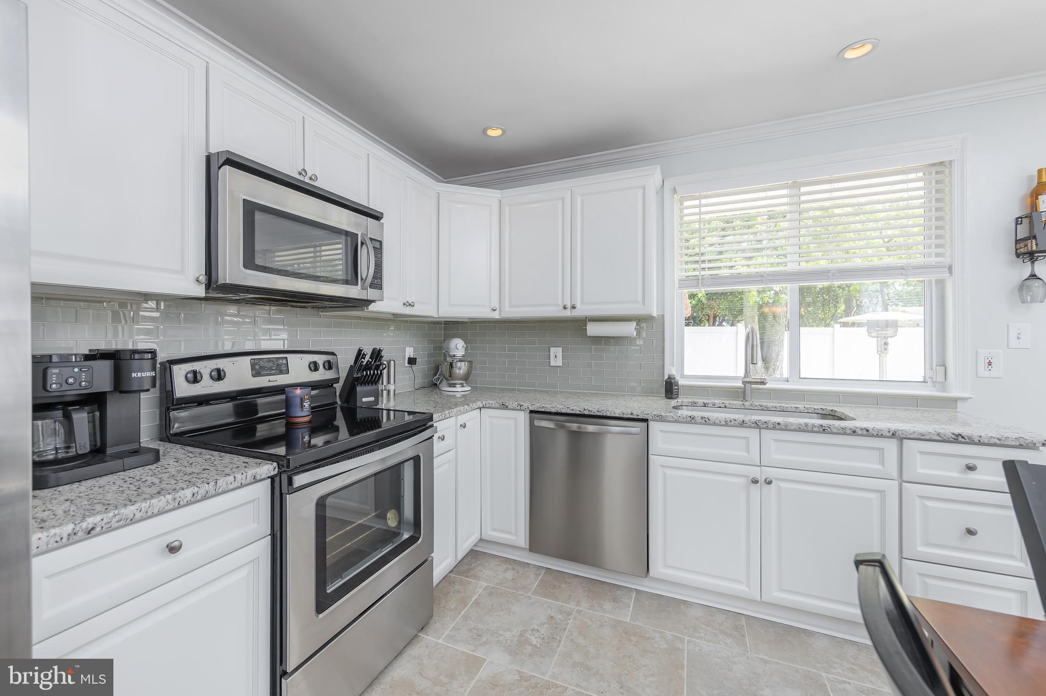 31 Hill Drive Pine Hill, NJ 08021 - Photo 5 of 27 a kitchen with granite countertop white cabinets and stainless steel appliances