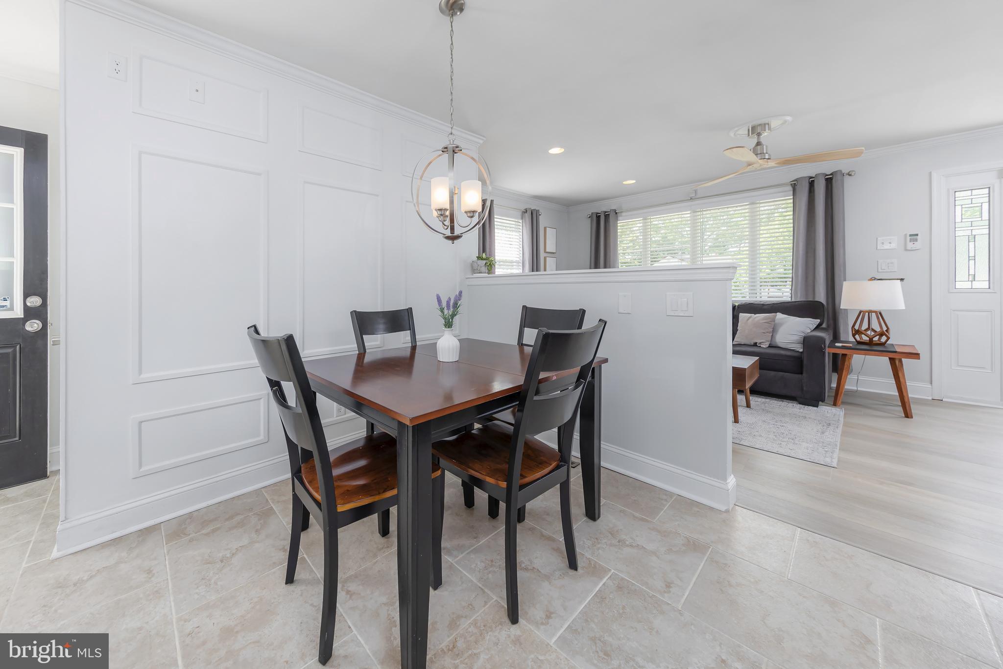 31 Hill Drive Pine Hill, NJ 08021 - Photo 7 of 27 a view of a dining room and livingroom with furniture wooden floor a rug a painting and a chandelier