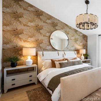 5126 Teaberry Lane, Unit 25 Fishkill, NY 12524 - Photo 6 of 9 a bedroom with a bed a chandelier and a potted plant