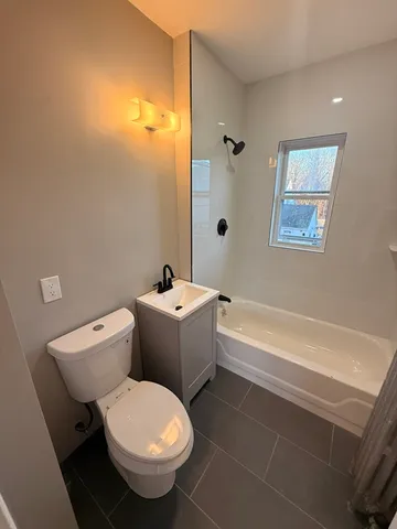 a bathroom with a toilet a sink and bathtub