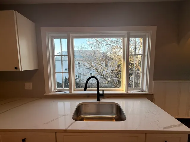 a bathroom with a sink and a window