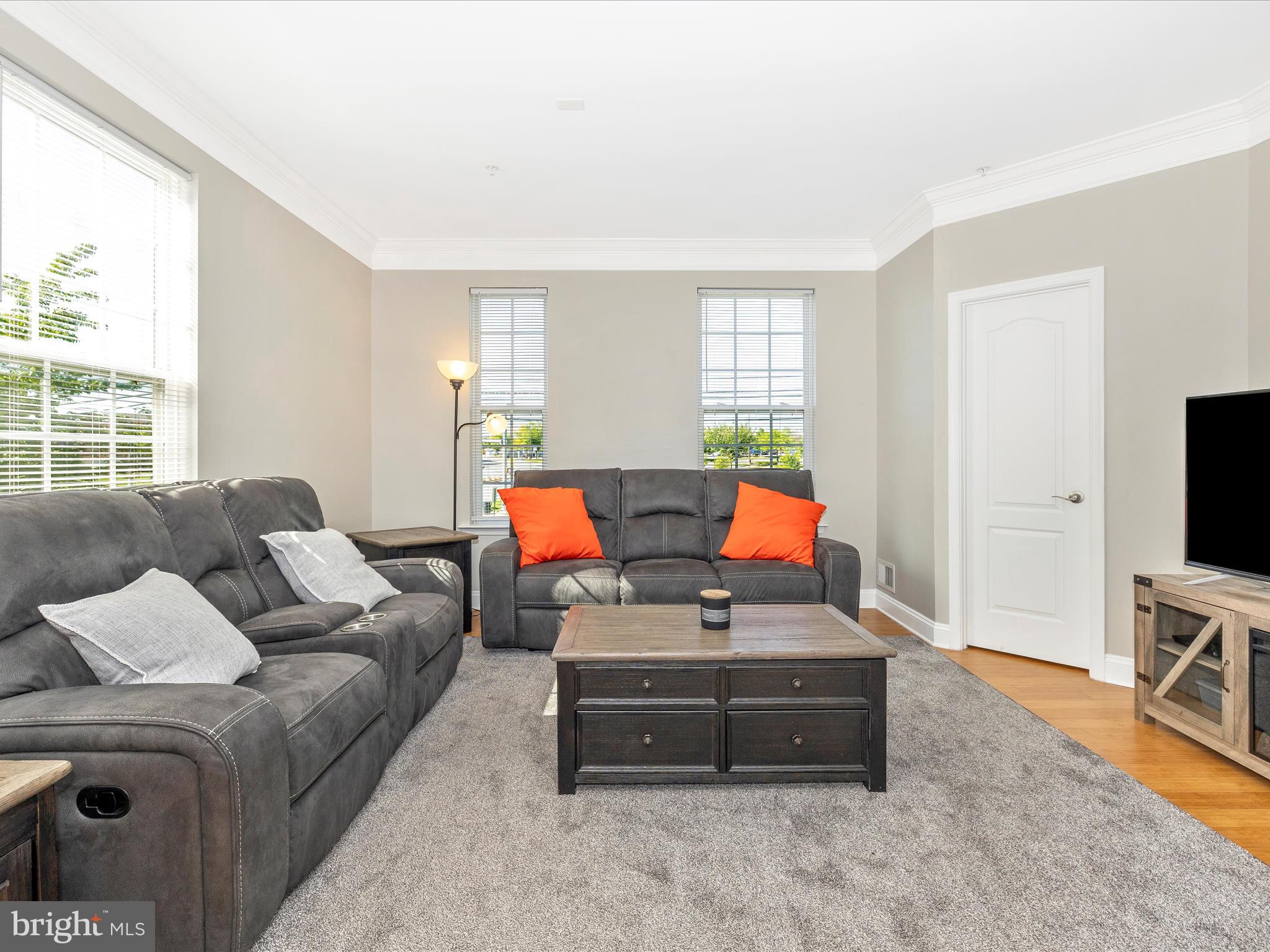 7801 Wormans Mill Road Frederick, MD 21701 - Photo 13 of 35 a living room with furniture and a flat screen tv