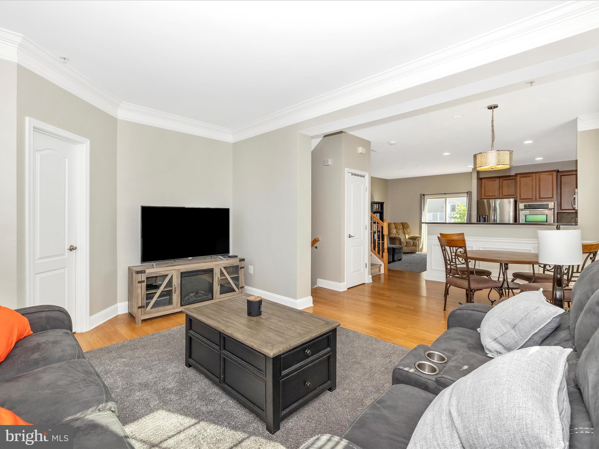 7801 Wormans Mill Road Frederick, MD 21701 - Photo 15 of 35 a living room with furniture and a flat screen tv