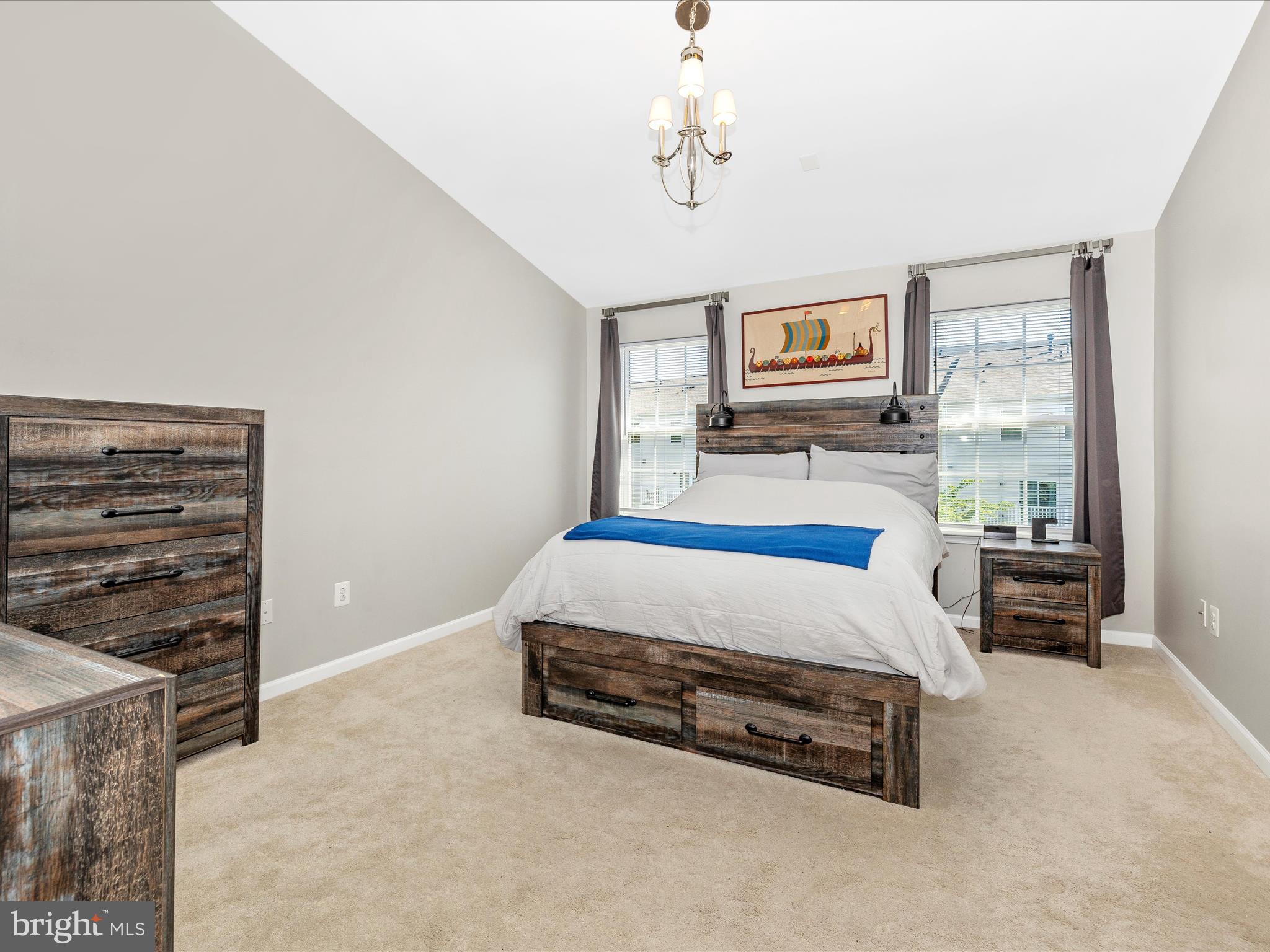 7801 Wormans Mill Road Frederick, MD 21701 - Photo 20 of 35 a bedroom with a bed and a chandelier