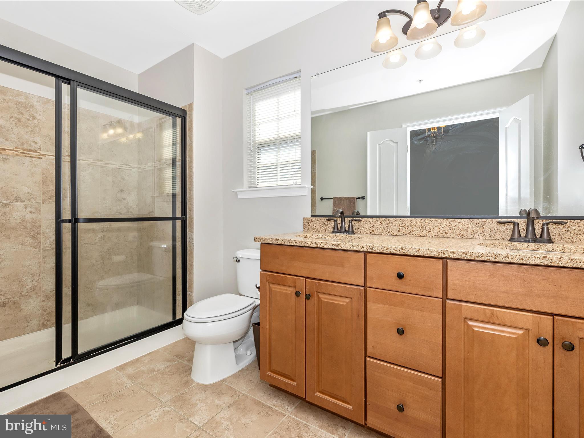 7801 Wormans Mill Road Frederick, MD 21701 - Photo 23 of 35 a bathroom with a double vanity sink toilet and a mirror