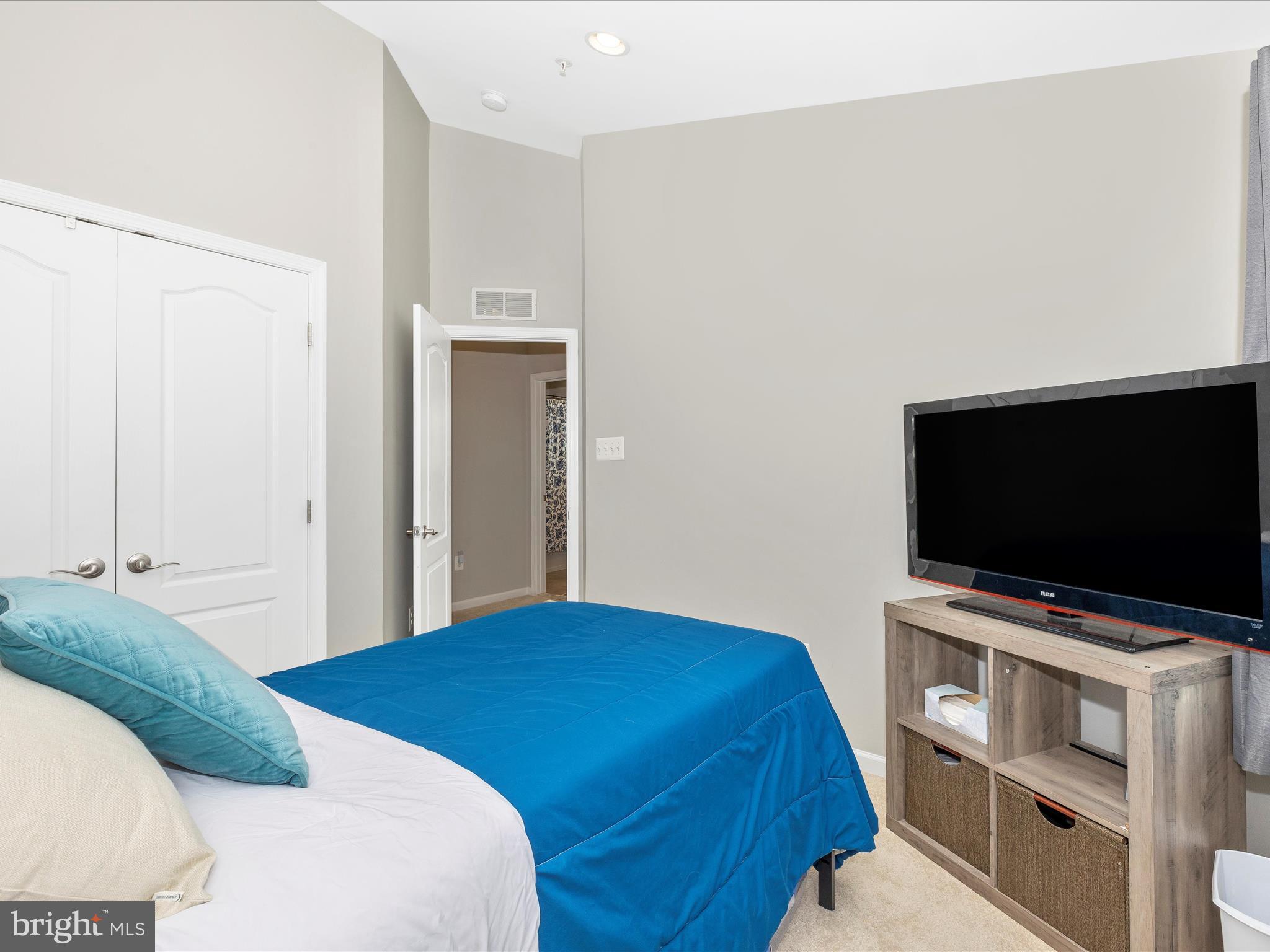 7801 Wormans Mill Road Frederick, MD 21701 - Photo 24 of 35 a bedroom with a bed and a flat screen tv