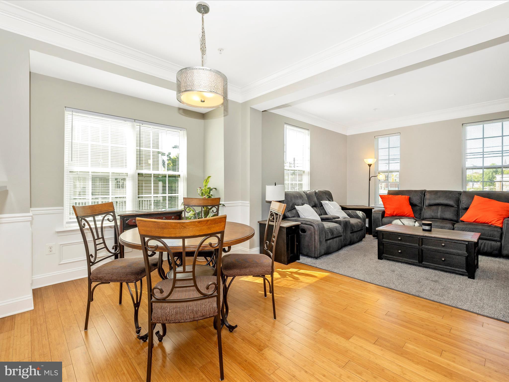 7801 Wormans Mill Road Frederick, MD 21701 - Photo 7 of 35 a living room with furniture a fireplace and a floor to ceiling window