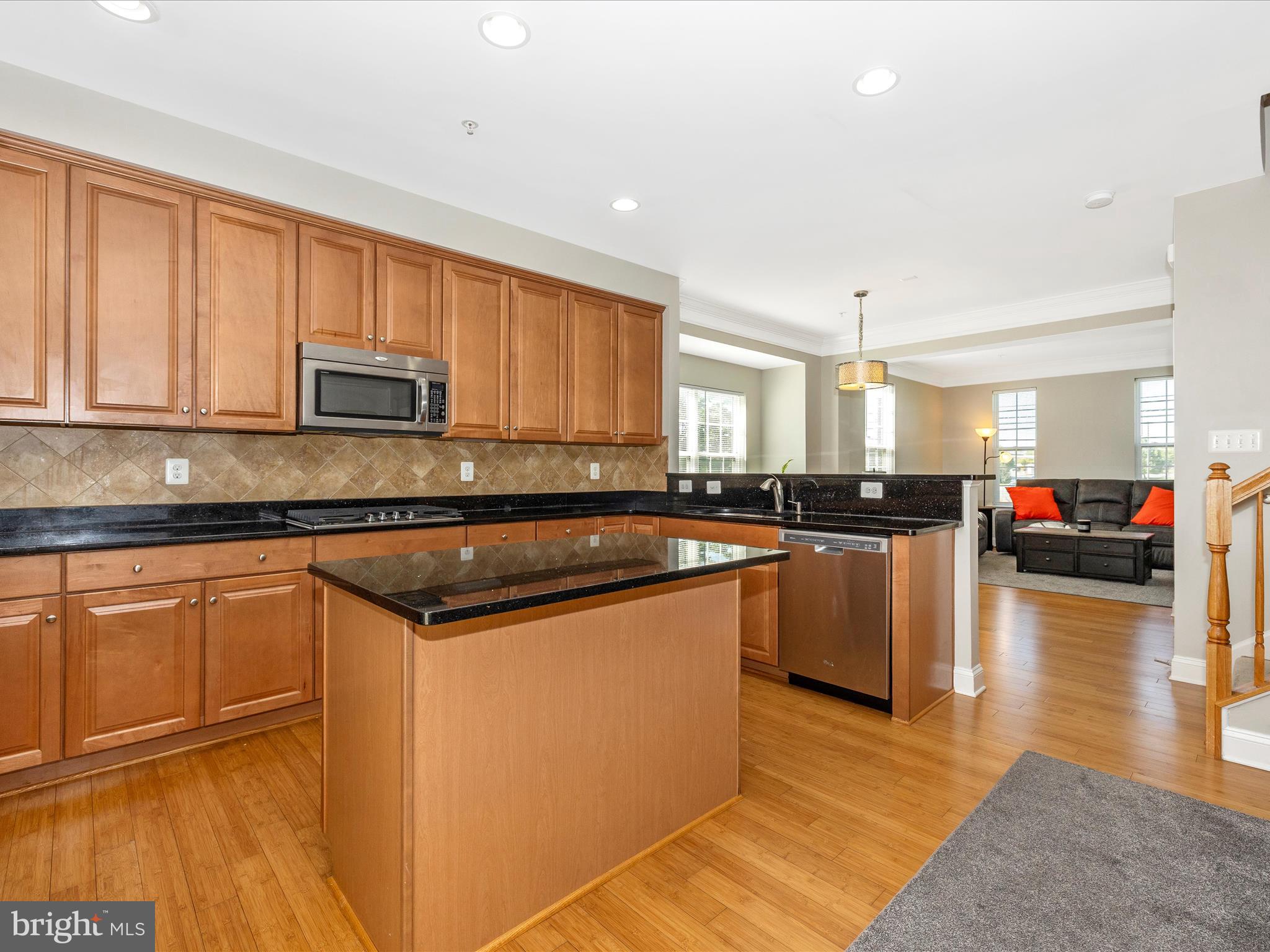 7801 Wormans Mill Road Frederick, MD 21701 - Photo 10 of 35 a kitchen with stainless steel appliances granite countertop a stove a sink and a microwave