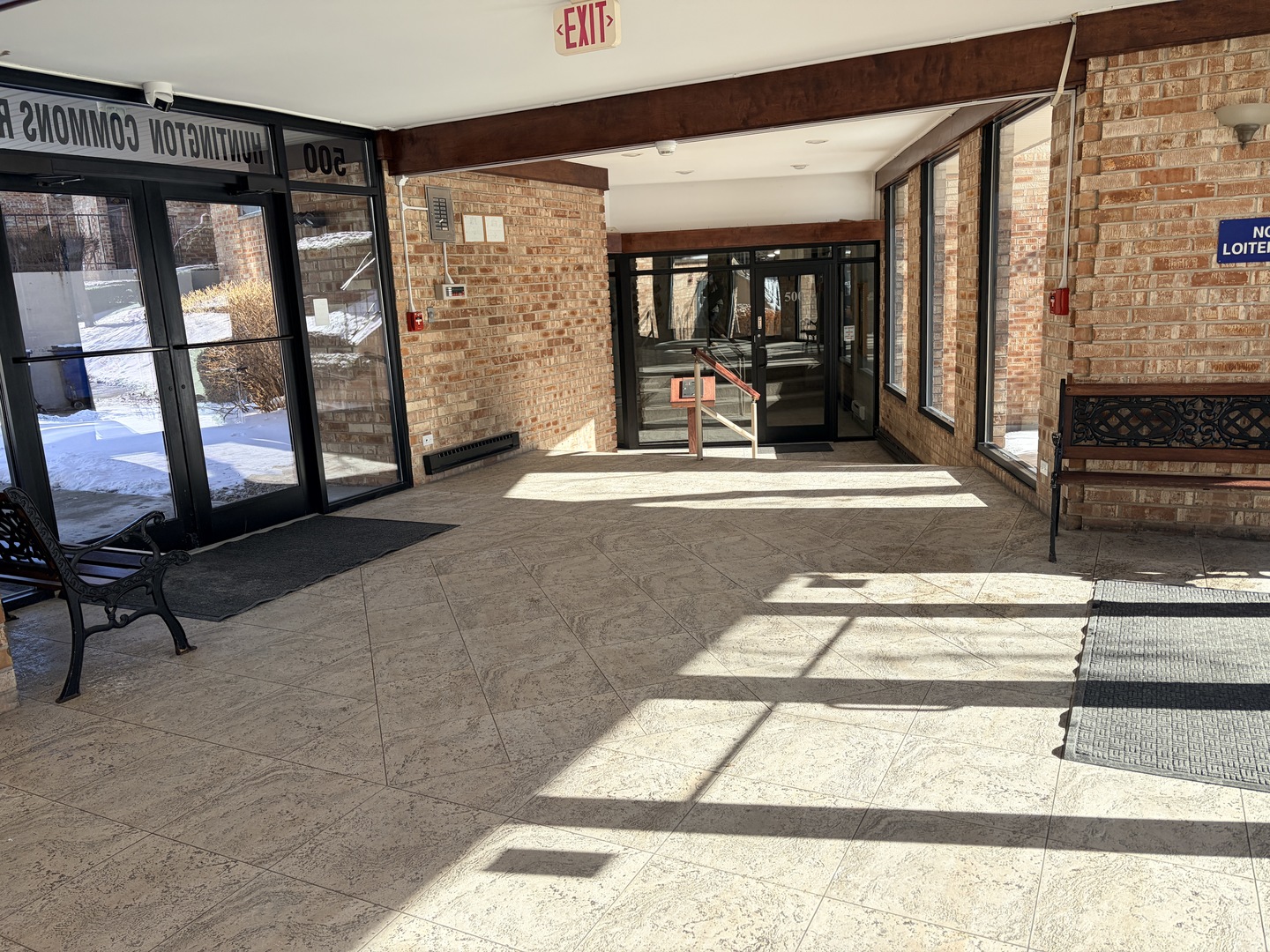 500 West Huntington Commons Road, Unit 255 Mount Prospect, IL 60056 - Photo 3 of 5 a living room filled with furniture and large window