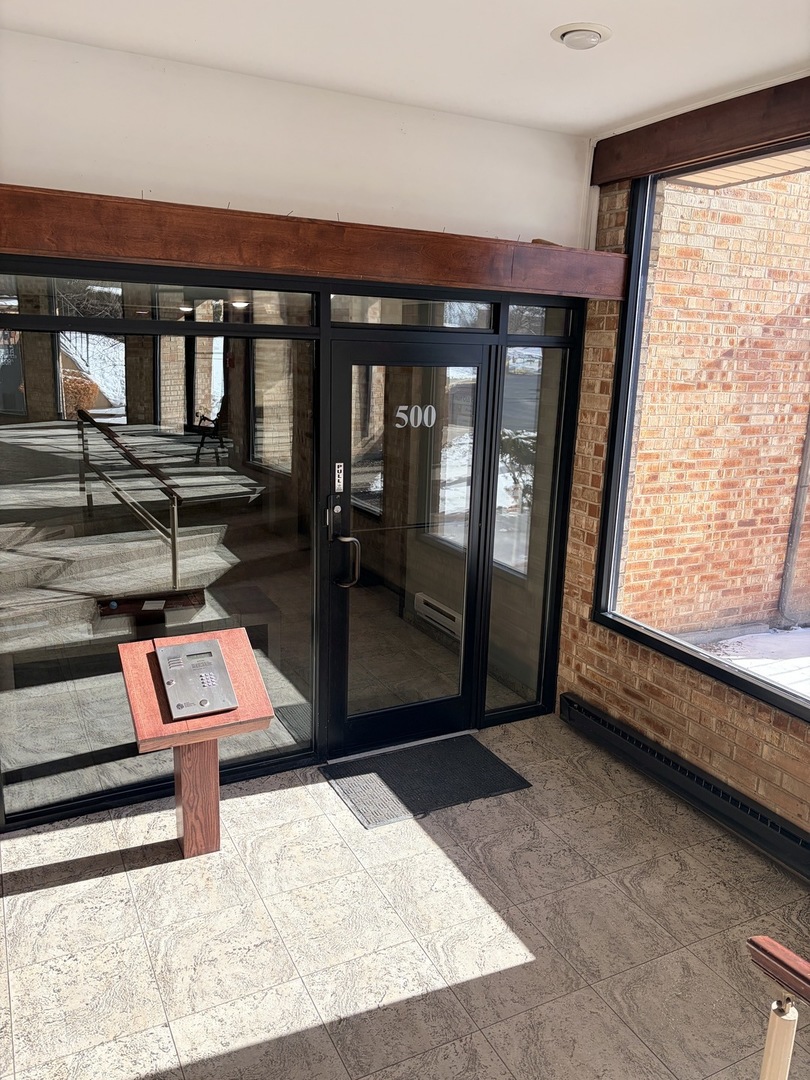 500 West Huntington Commons Road, Unit 255 Mount Prospect, IL 60056 - Photo 4 of 5 a room with wooden floor and a large window