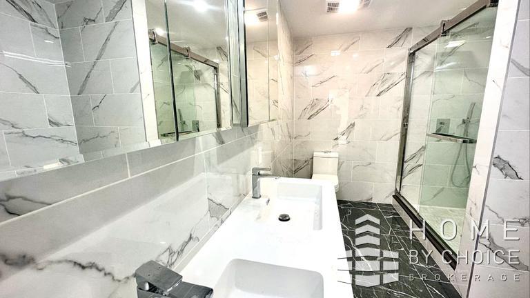 25 Peck Slip, Unit 3 Manhattan, NY 10038 - Photo 12 of 15 a bathroom with a bathtub and a shower