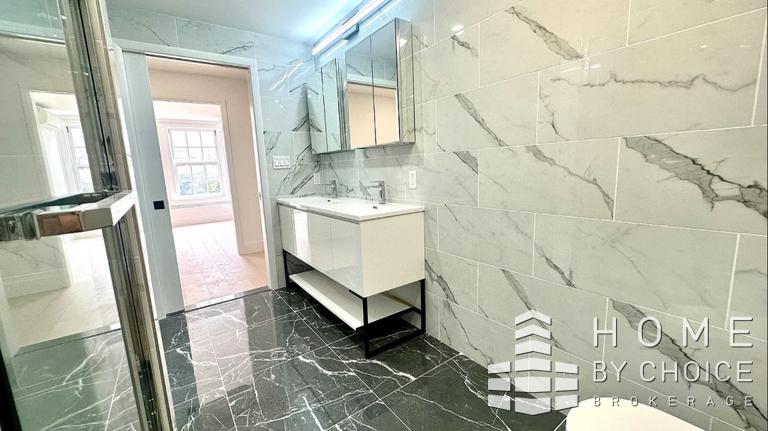 25 Peck Slip, Unit 3 Manhattan, NY 10038 - Photo 13 of 15 a bathroom with a sink and mirror with bathtub