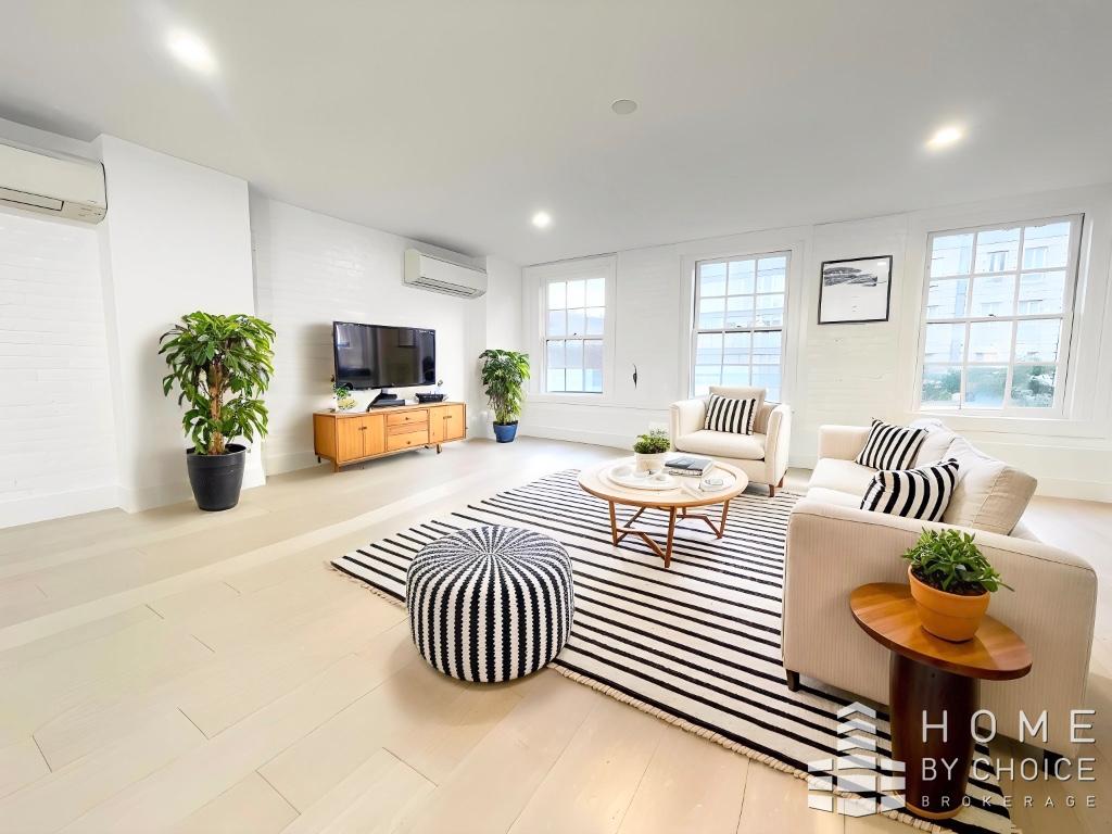 25 Peck Slip, Unit 3 Manhattan, NY 10038 - Photo 6 of 15 a bedroom with furniture and a large window