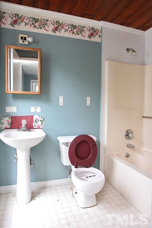 520 Chavis Way Raleigh, NC 27601 - Photo 11 of 13 a white toilet sitting next to a bathroom sink