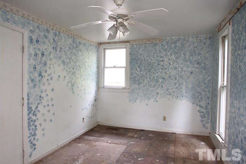 520 Chavis Way Raleigh, NC 27601 - Photo 9 of 13 an empty room with windows and fan