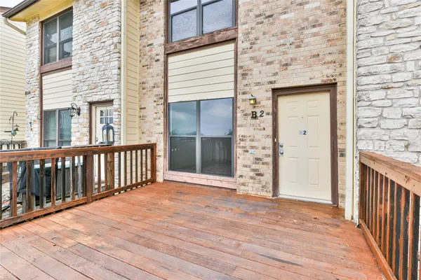 a view of a balcony with wooden floor