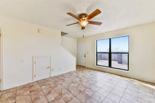 a view of a livingroom with a ceiling fan and window