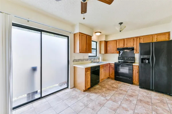 a kitchen with granite countertop a refrigerator and a sink