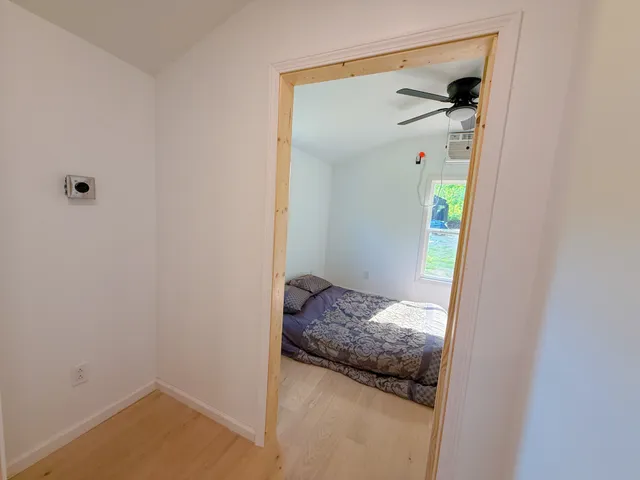 a bedroom with a bed and hallway