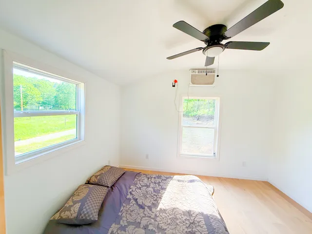 a bedroom with a bed and a window