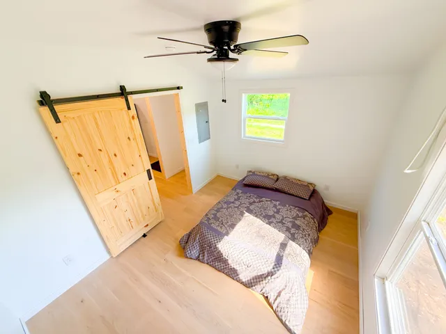 a bedroom with a bed and a window