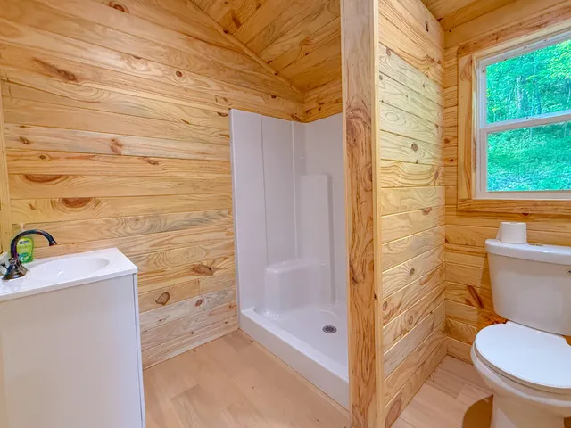 a bathroom with a toilet and a shower