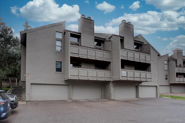 a view of a tree in the backyard of a house