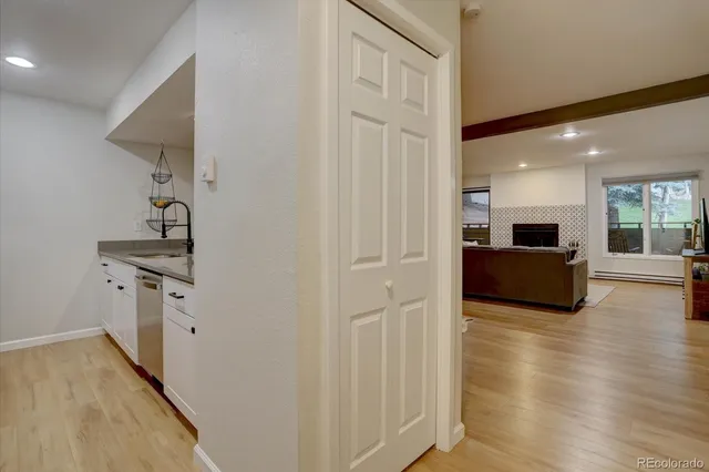 a view of a kitchen with sink and dishwasher wooden floor