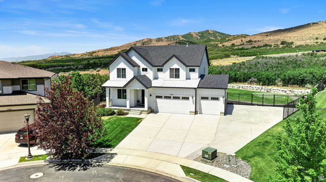 6536 West Muirfield Road Highland, UT 84003 - Photo 1 of 48 Modern farmhouse-style residence featuring a prominent white exterior with black trim accents and a contrasting dark shingle roof
