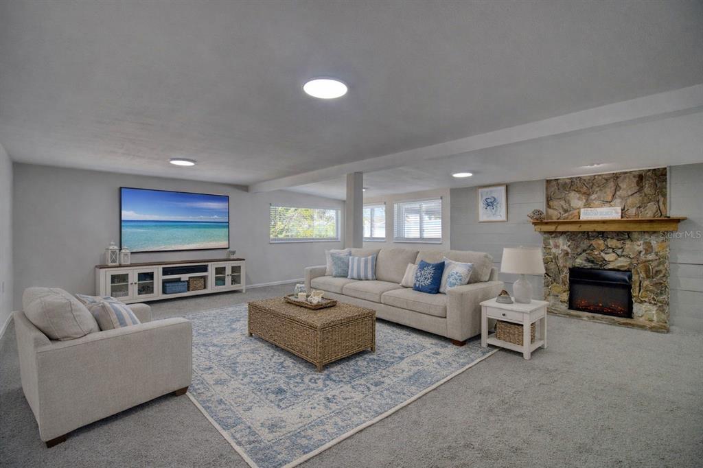 6820 Sea Ranch Drive Hudson, FL 34667 - Photo 4 of 29 a living room with furniture a fireplace and a flat screen tv