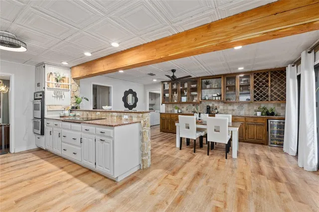 a large kitchen with kitchen island a sink stainless steel appliances and cabinets