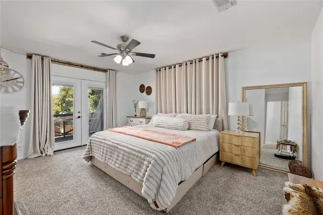 a spacious bedroom with a bed and a chandelier