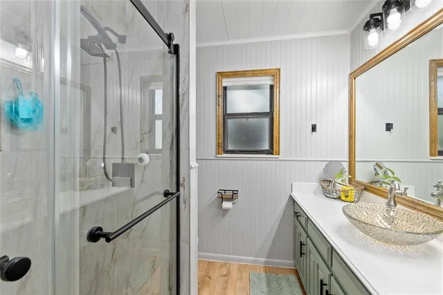 a bathroom with a shower sink and mirror