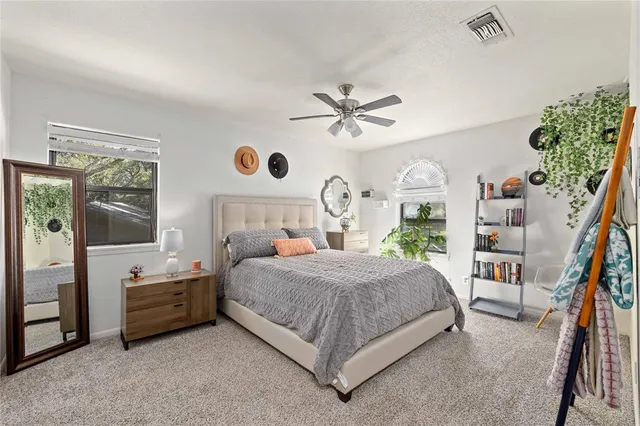 a bedroom with a large bed and a chandelier