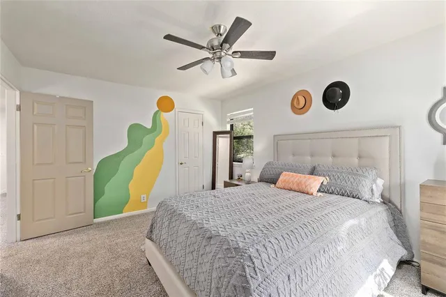 a bedroom with a bed and a large window